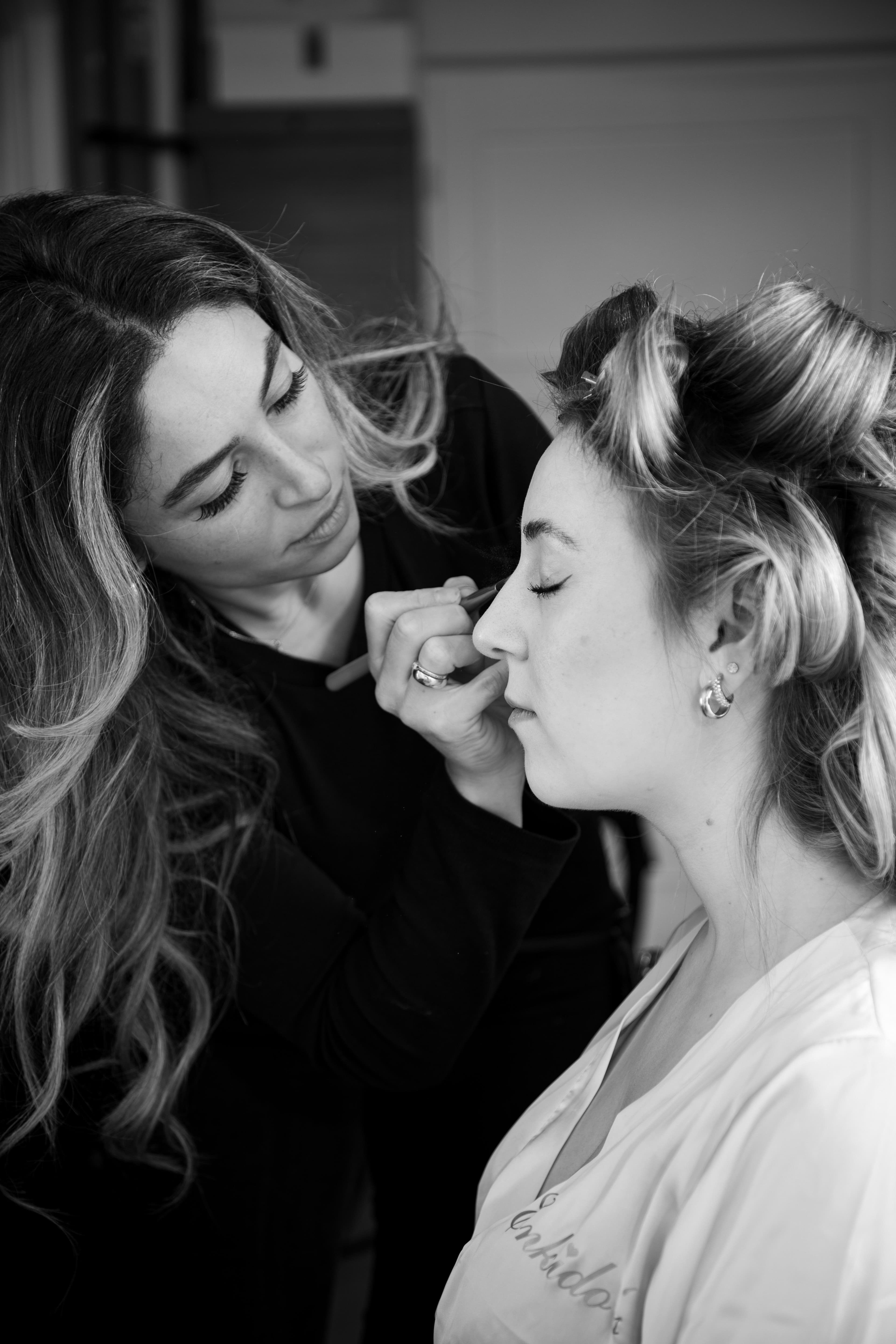 Beautician applying luxury makeup at Revolet Makeup Studio