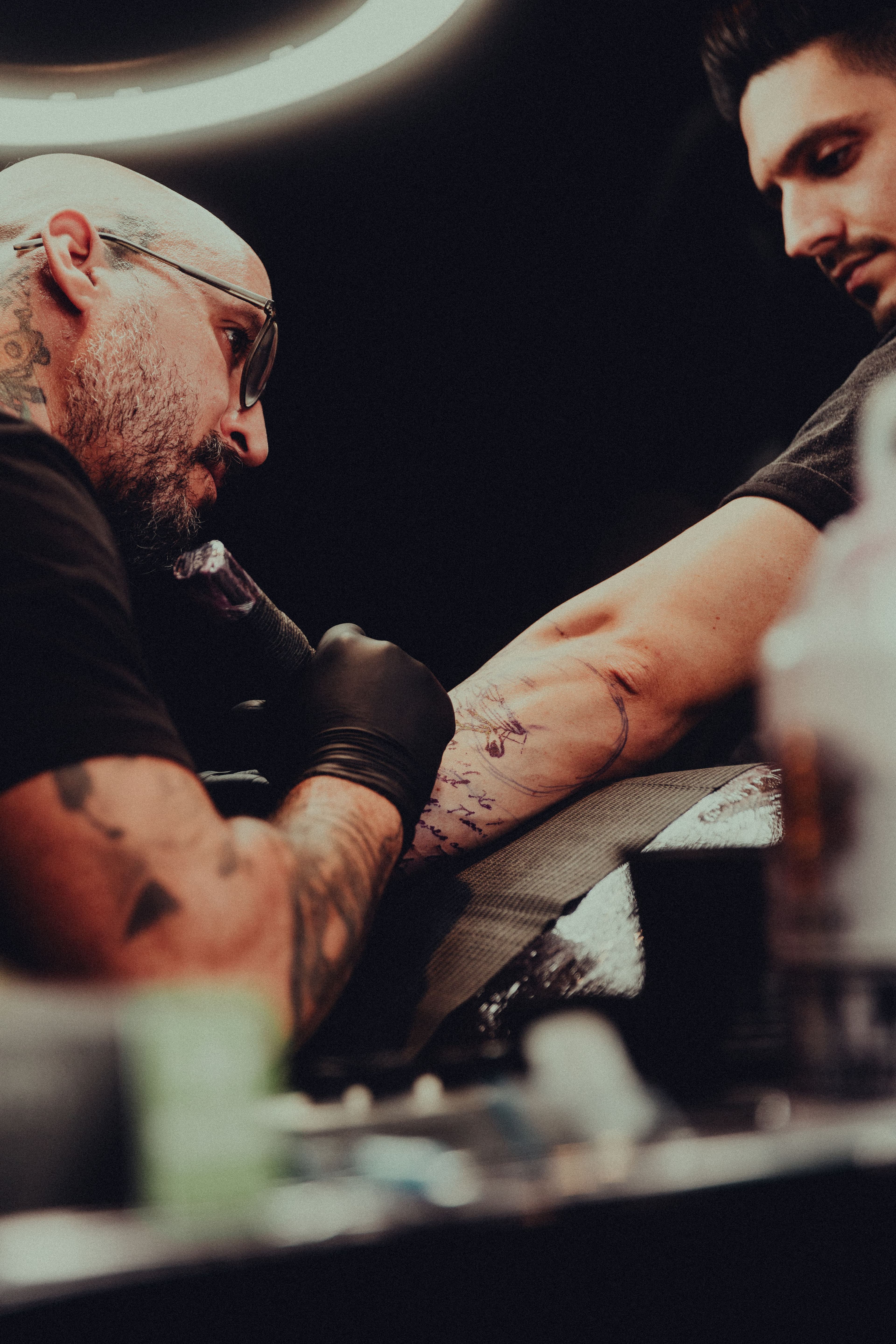 Tattoo artist crafting custom tattoo design